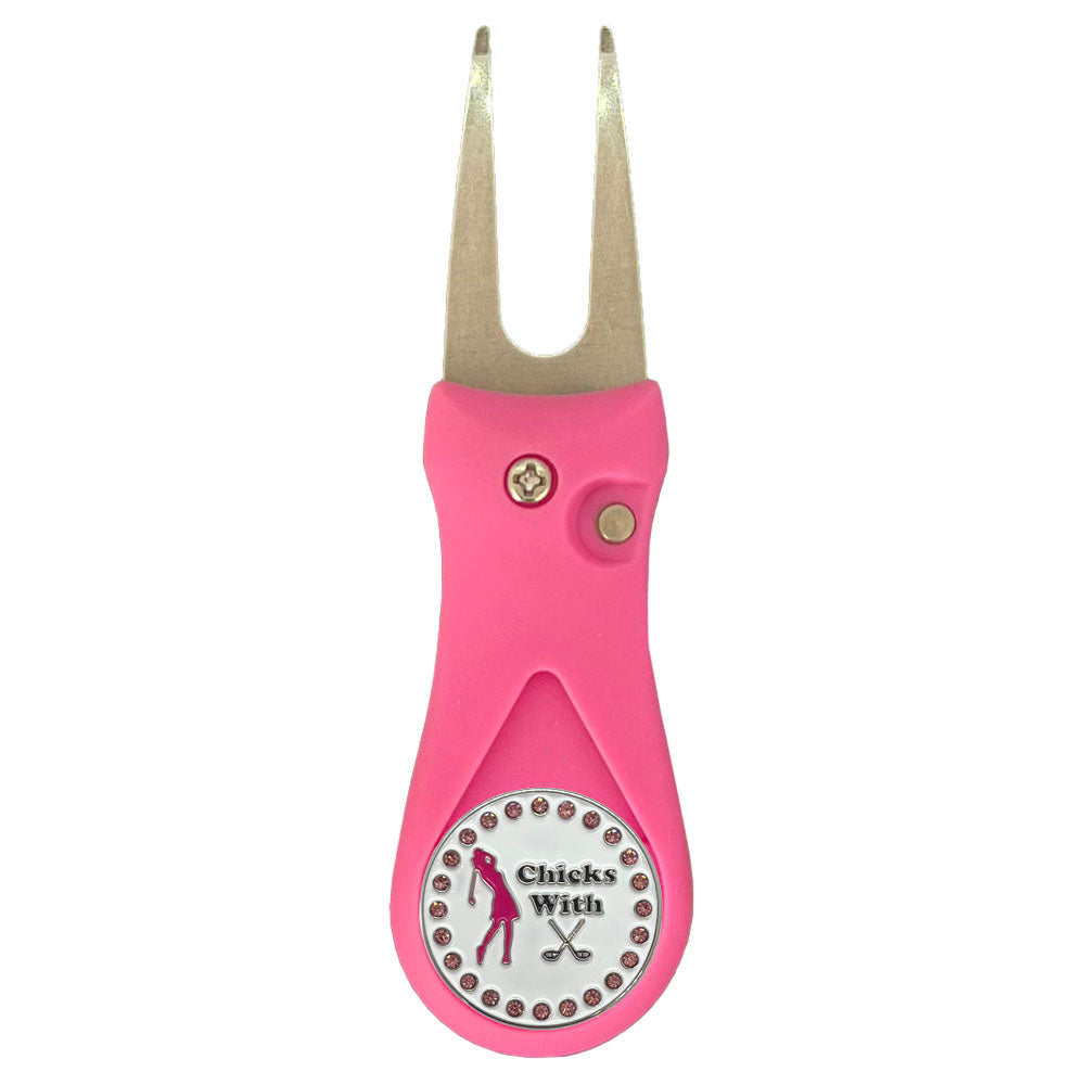 Pink golf divot tool with a chicks with sticks golf ball marker on a white background