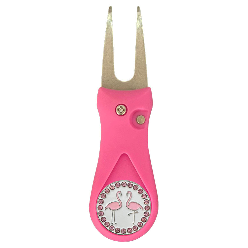 Pink golf divot tool with flamingo design on a white background