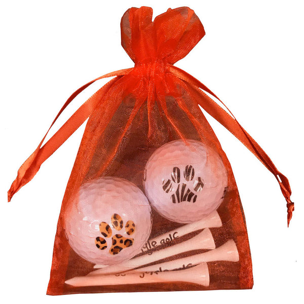 leopard and zebra print golf balls with four wooden golf tees