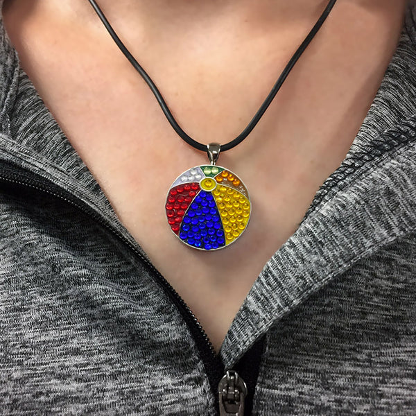 a woman wearing the bling colorful beach ball golf ball marker necklace