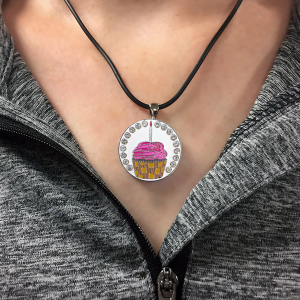 a woman wearing a bling cupcake golf ball marker necklace