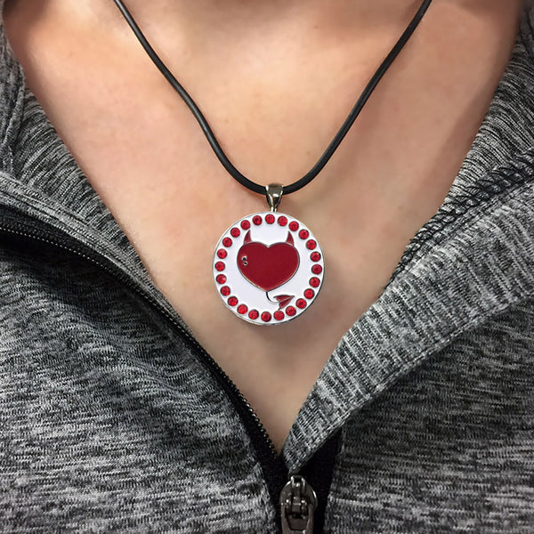 a woman wearing a bling devilish heart golf ball marker necklace