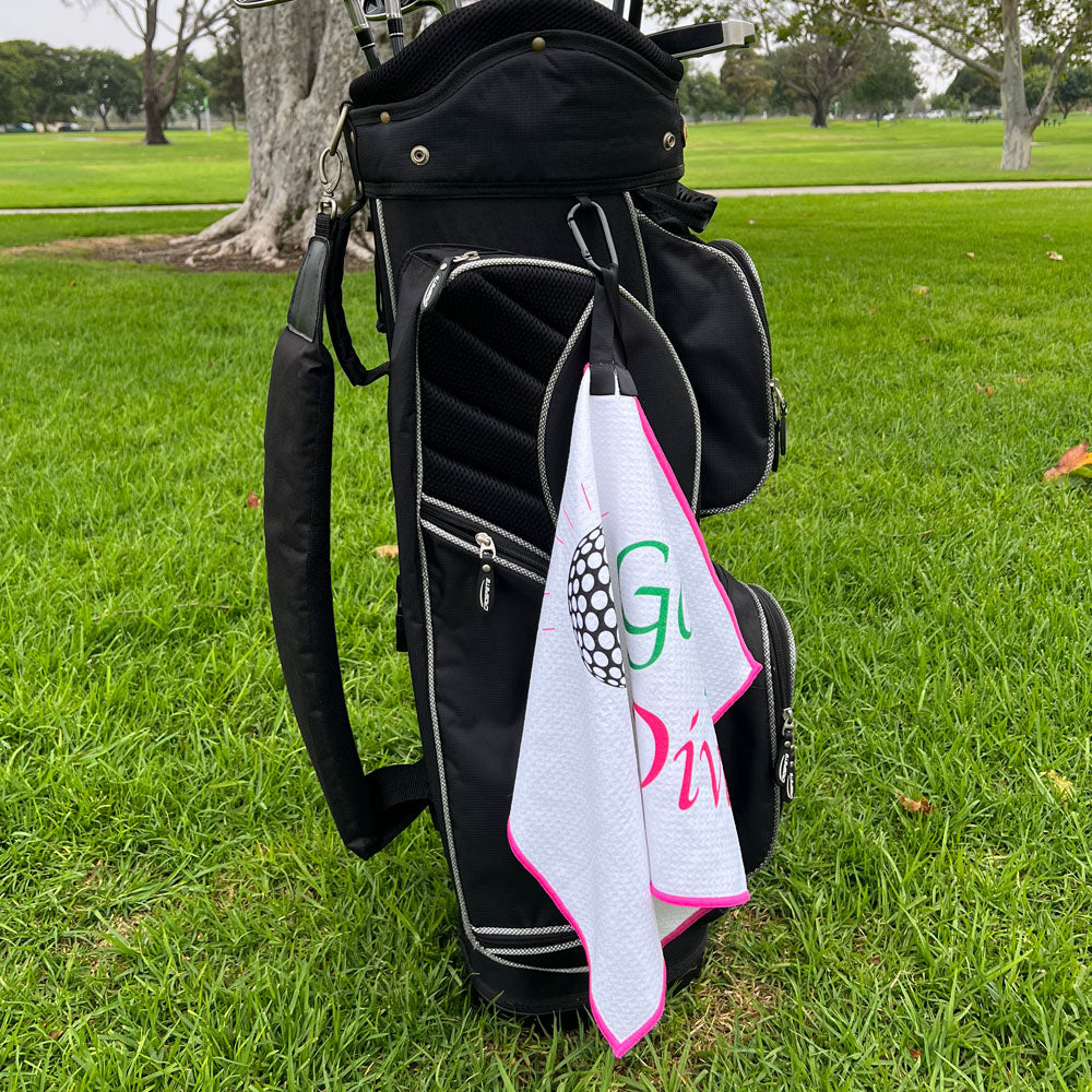 martini golf towel hanging on a golf bag, on a golf course