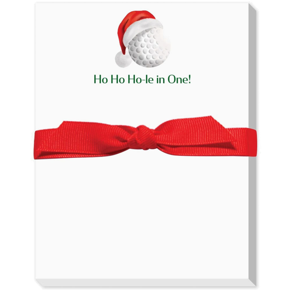 Golf ball with Santa hat on a white notepad with red ribbon, text 'Ho Ho Ho-le in One!'