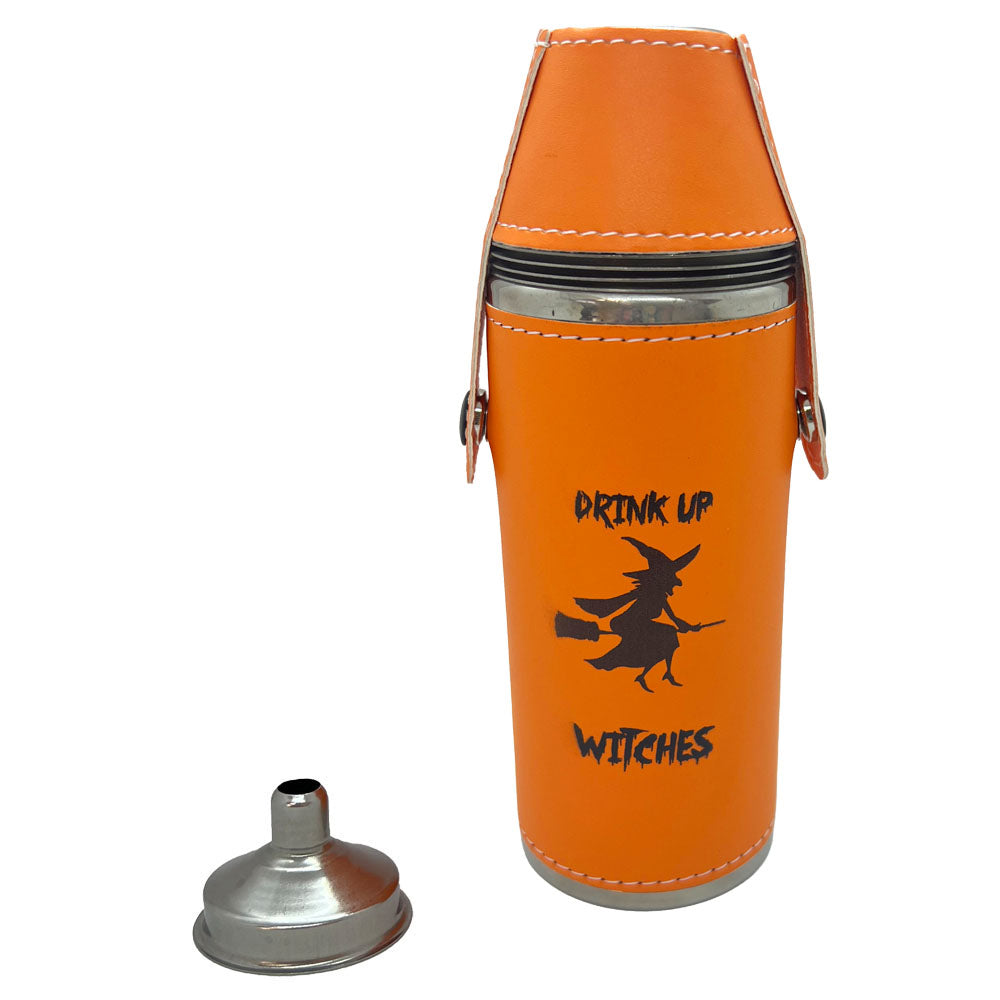 An orange 8 oz flask with with 4 shot glasses, and the orange sleeve is featuring a black witch graphic and the text 'DRINK UP WITCHES', shown with a separate silver funnel on a white background.