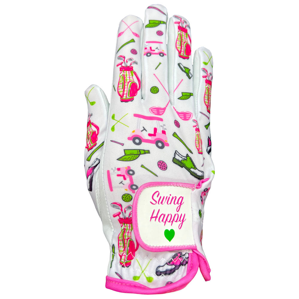 Women’s Swing Happy golf glove showing pink and green golf cart, bag, and shoe pattern with a "Swing Happy" adjustable velcro strap.
