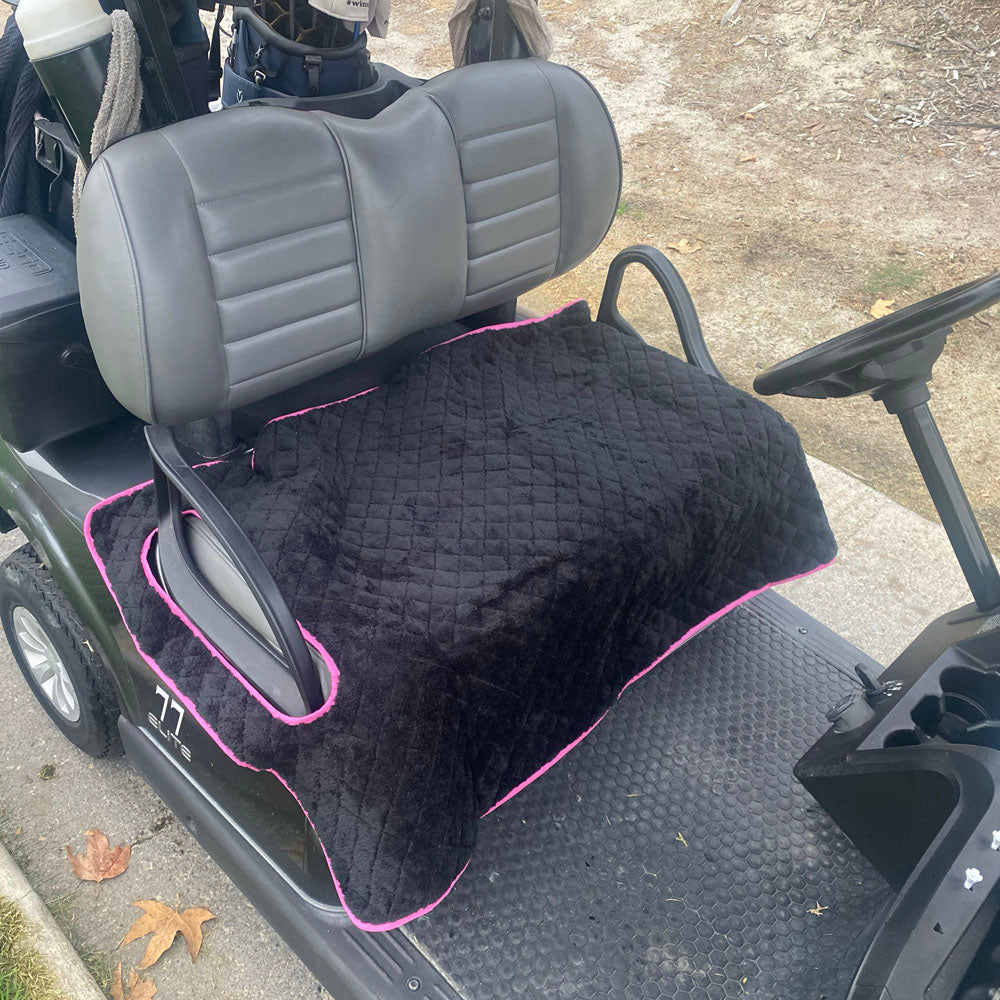 Reversible soft black fleece side of the Flamingo golf cart seat cover installed on a cart seat.