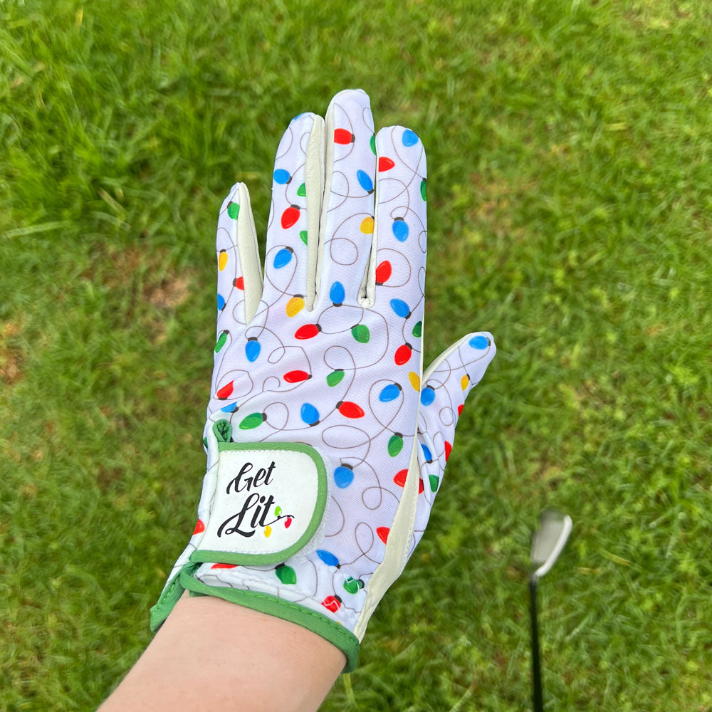 A right-handed, female golfer, wearing a Giggle Golf Get Lit golf glove during her golf event.