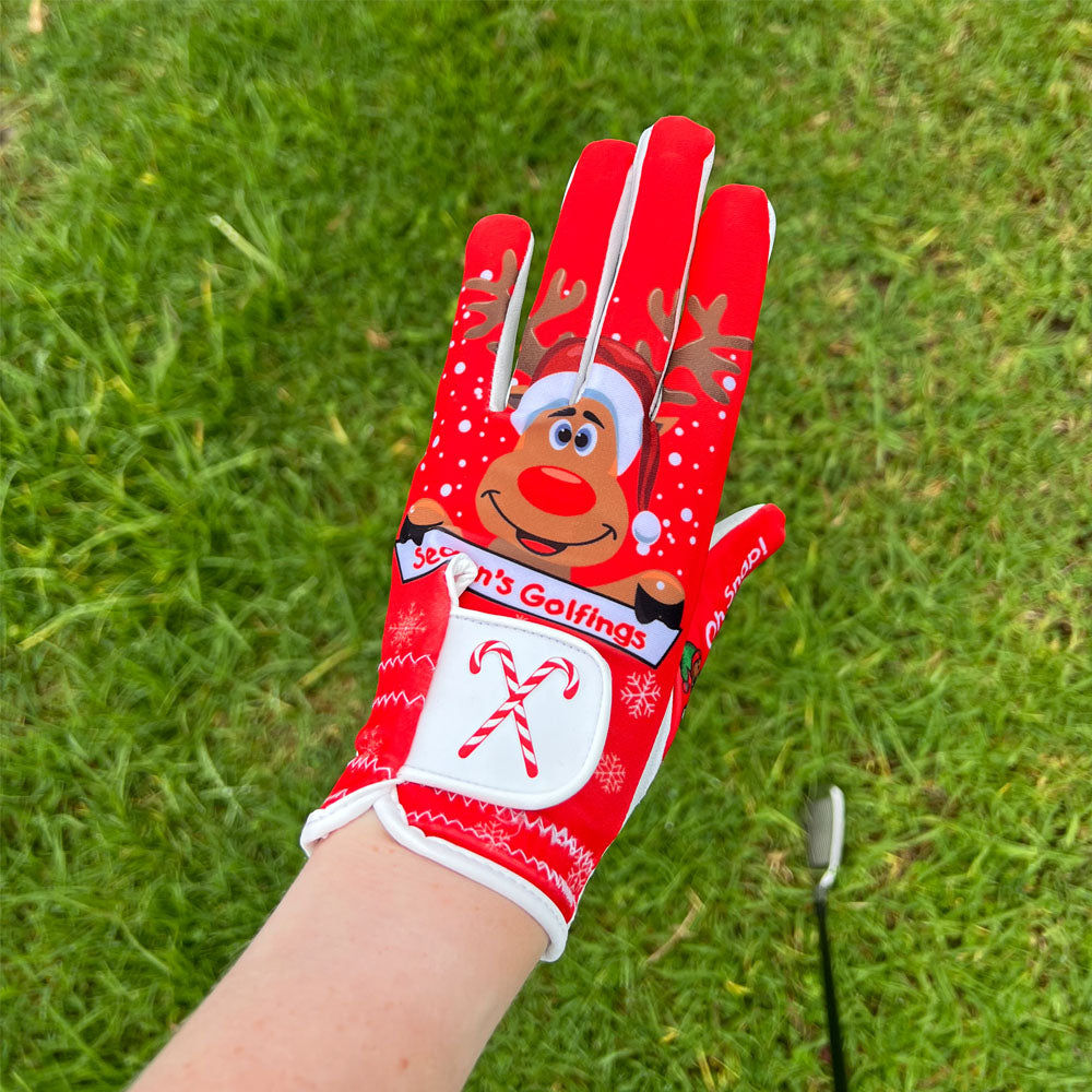 A right-handed, female golfer, wearing a red Holiday golf glove during her Christmas golf tournament.