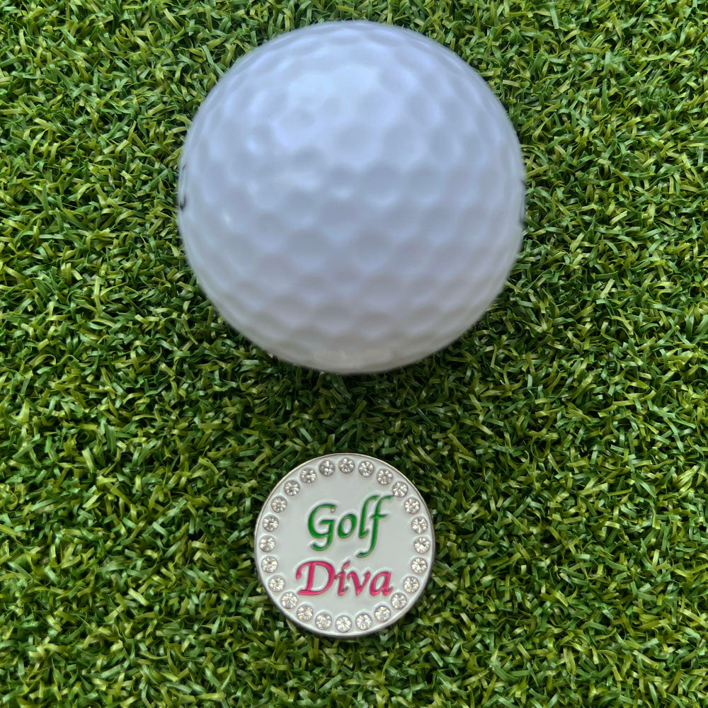 Golf ball on green grass with a 'Golf Diva' marker