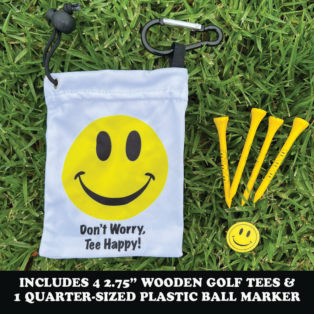 Smiley face golf bag with plastic ball marker and wooden tees on grass