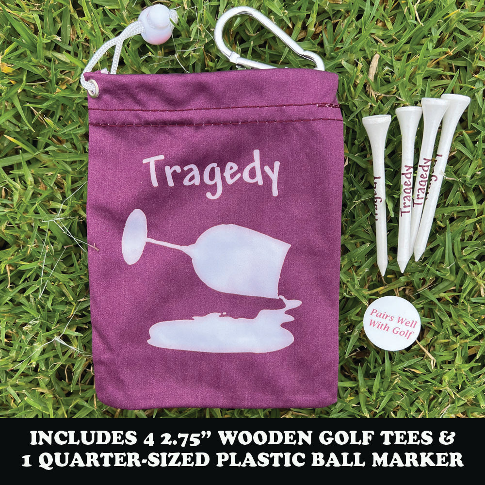 Maroon bag with 'Tragedy' text and golf accessories on grass