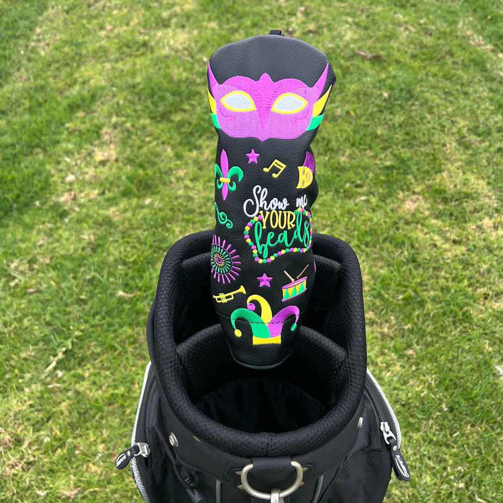 Golf club hybrid head cover with colorful Mardi Gras designs and text on a grass background