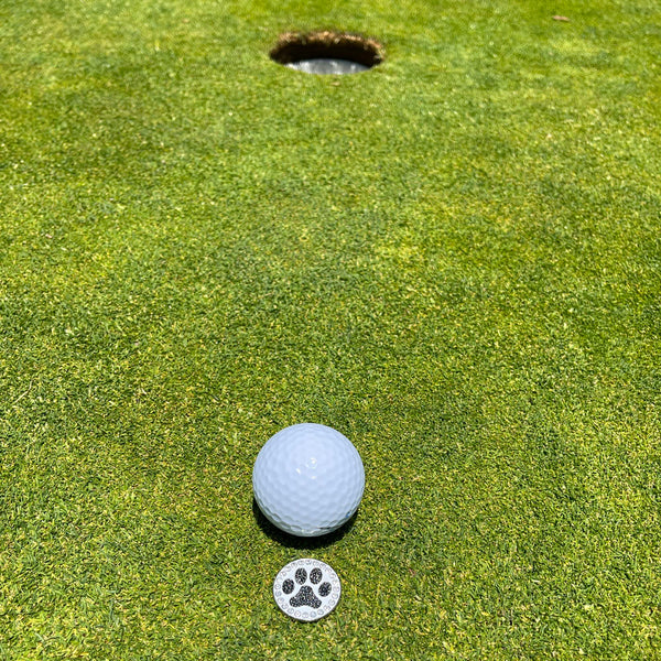 Giggle Golf Bling Paw Print (Black) On A Putting Green, Behind A White Golf Ball