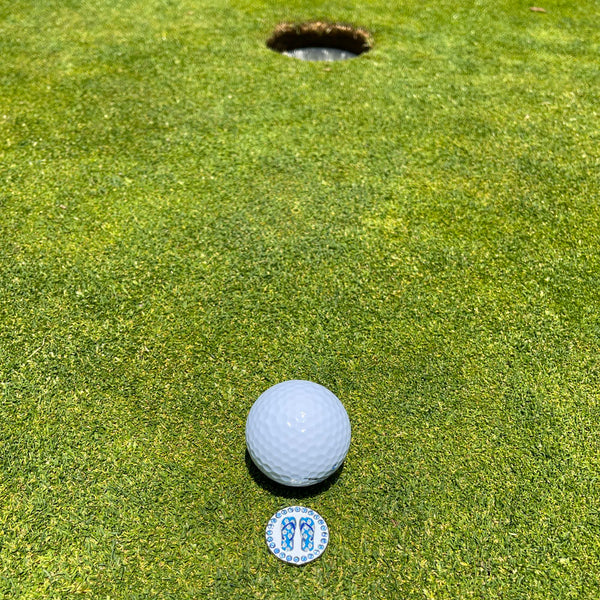 Giggle Golf Bling Blue Flip Flops On A Putting Green, Behind A White Golf Ball