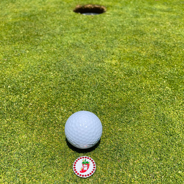 Giggle Golf Bling Chili Pepper Ball Marker On A Putting Green, Behind A White Golf Ball