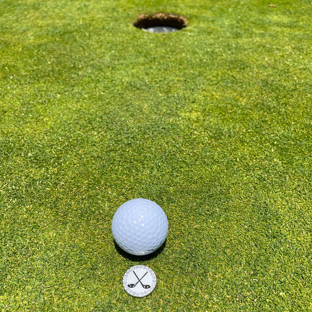 Giggle Golf Bling Crossed (Golf) Clubs On A Putting Green, Behind A White Golf Ball