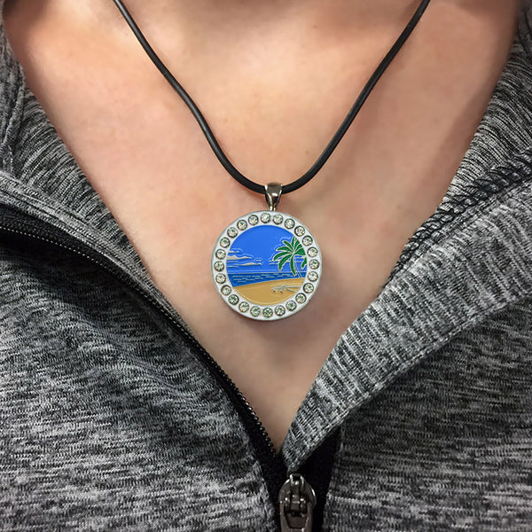 A Woman Wearing The Giggle Golf bling Beach Scene Golf Ball Marker Necklace