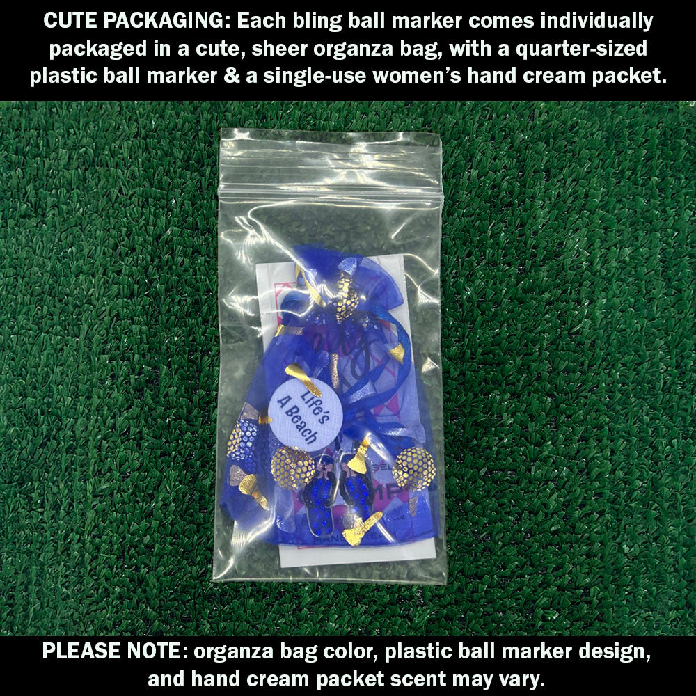 Cute packaging with bling blue flip flops ball marker, plastic ball marker, and hand cream packet on a green background.