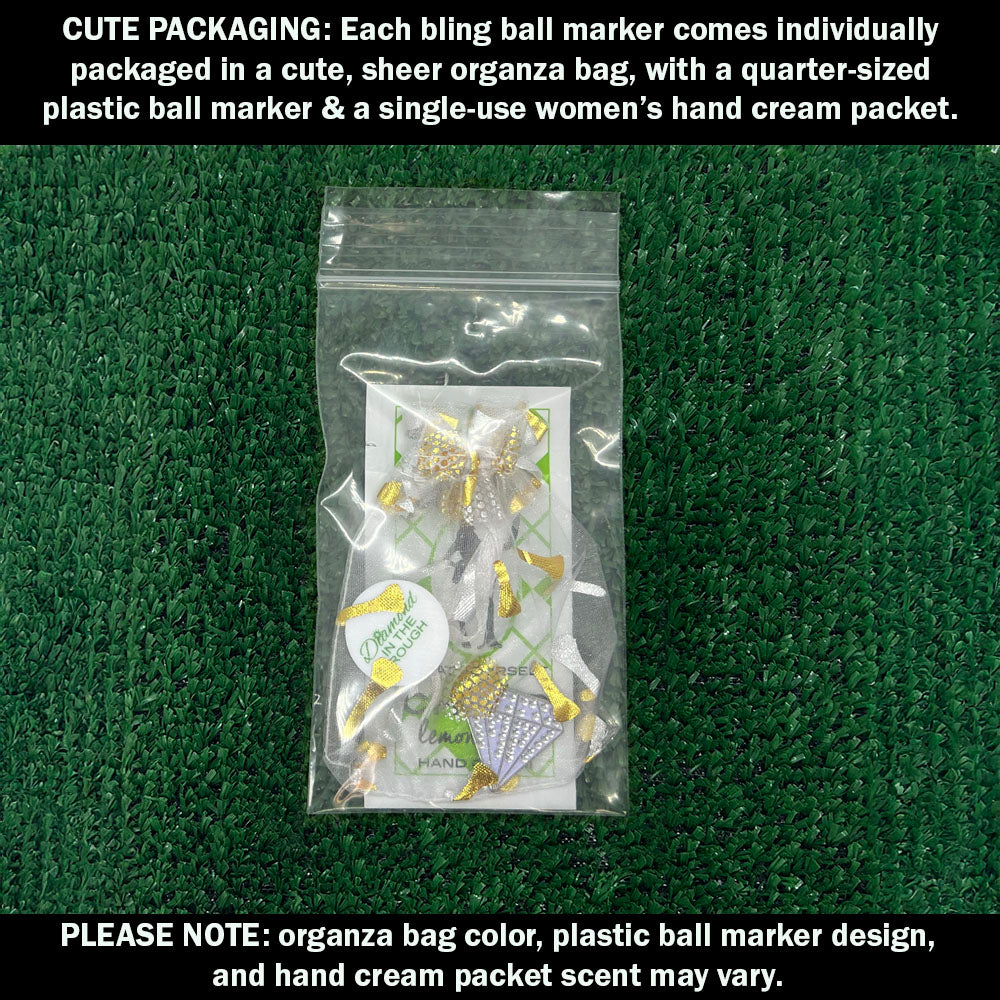 Cute packaging with bling white diamond ball marker, plastic ball marker, and hand cream packet on a green background.