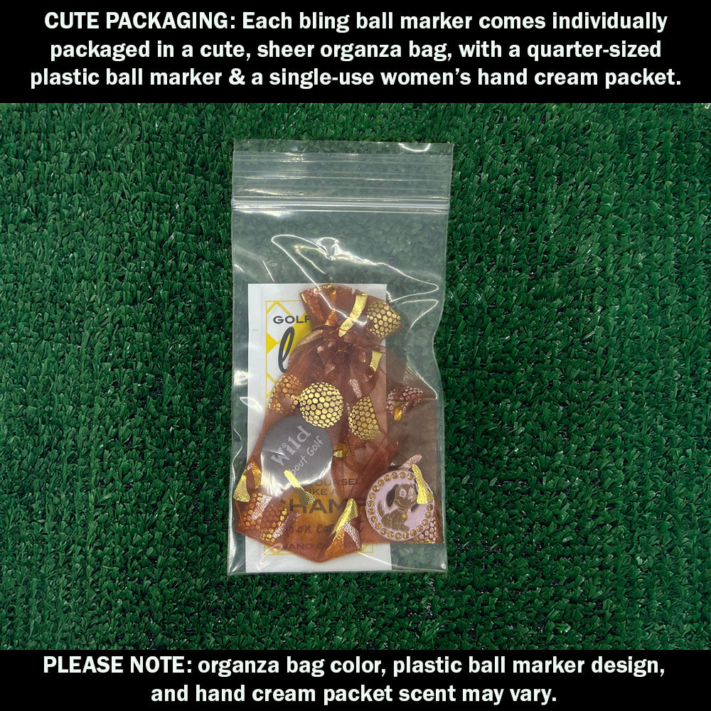 Cute packaging with bling dog ball marker, plastic ball marker, and hand cream packet on a green textured background.