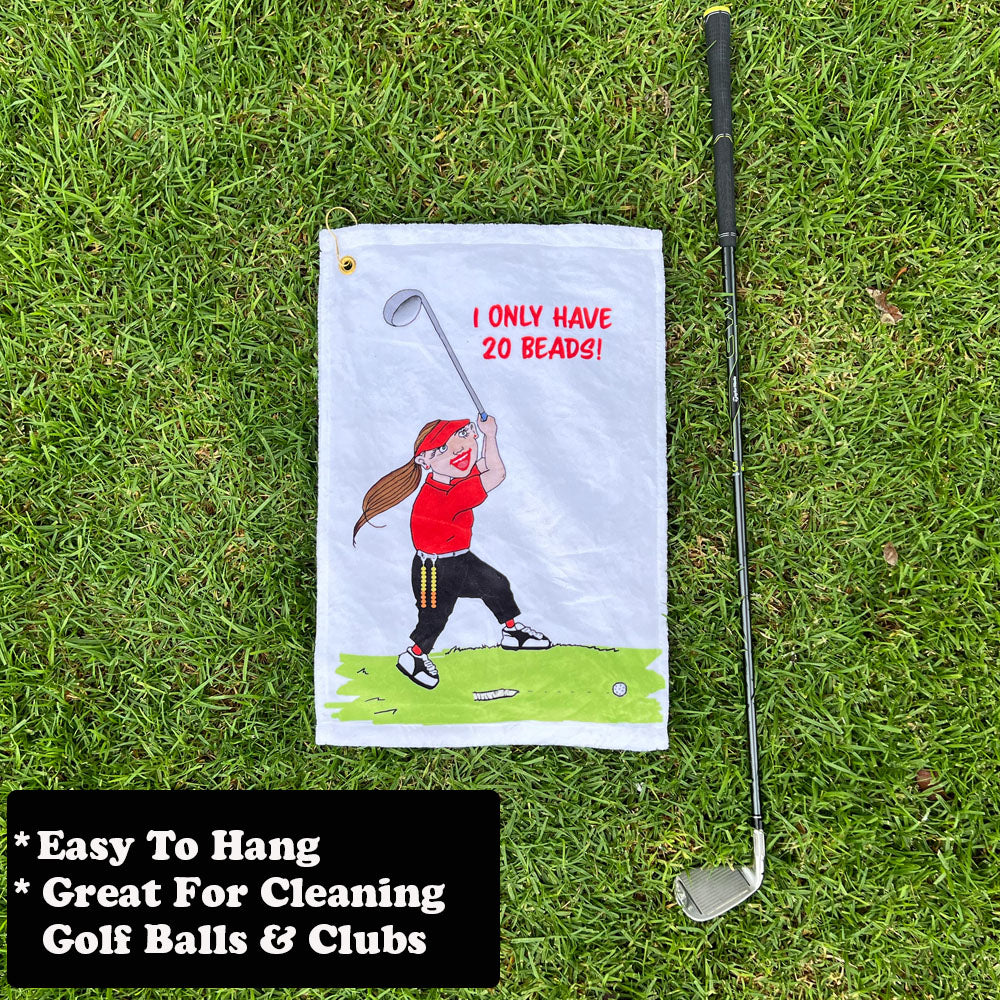 Golf towel with female golfer cartoon character and golf club on grass