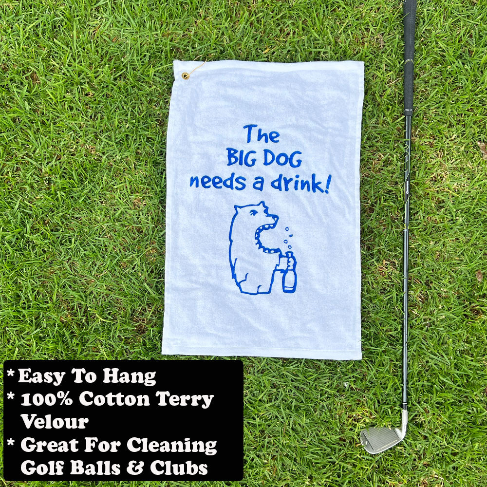 Golf towel with dog graphic and text on grass with golf club