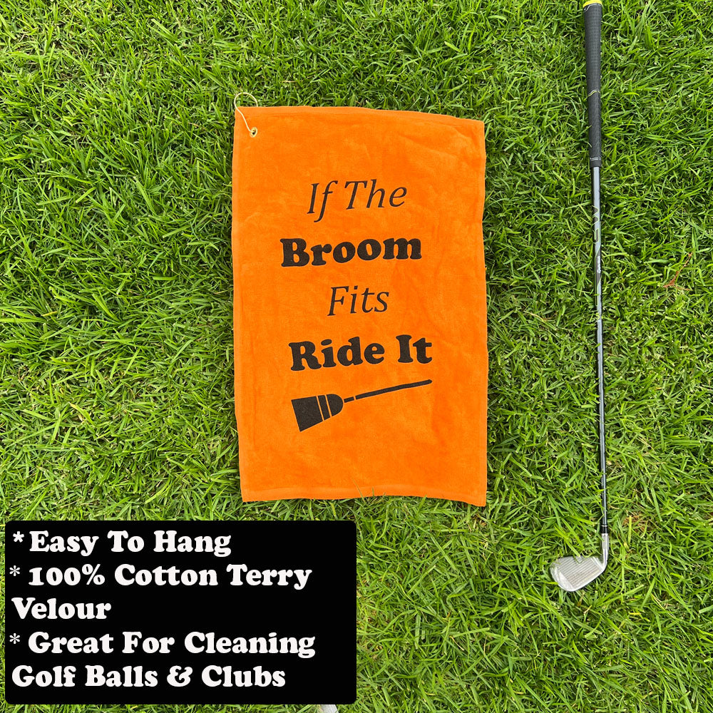 Orange Halloween themed towel with text on grass next to a golf club
