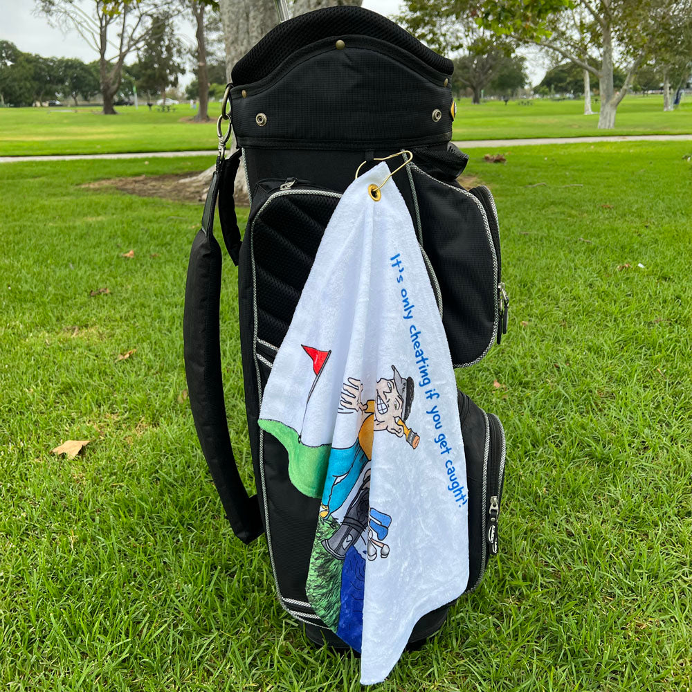 Golf bag with a towel featuring a cartoon male golfer on a grassy background