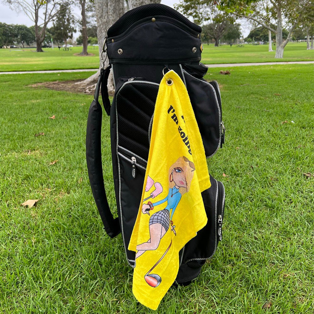 yellow golf towel with cartoon golfer on black golf bag