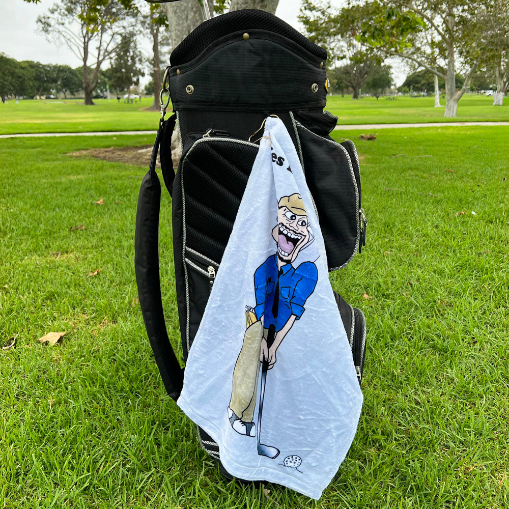 Golf bag with a grey towel featuring a cartoon golfer on a grassy field