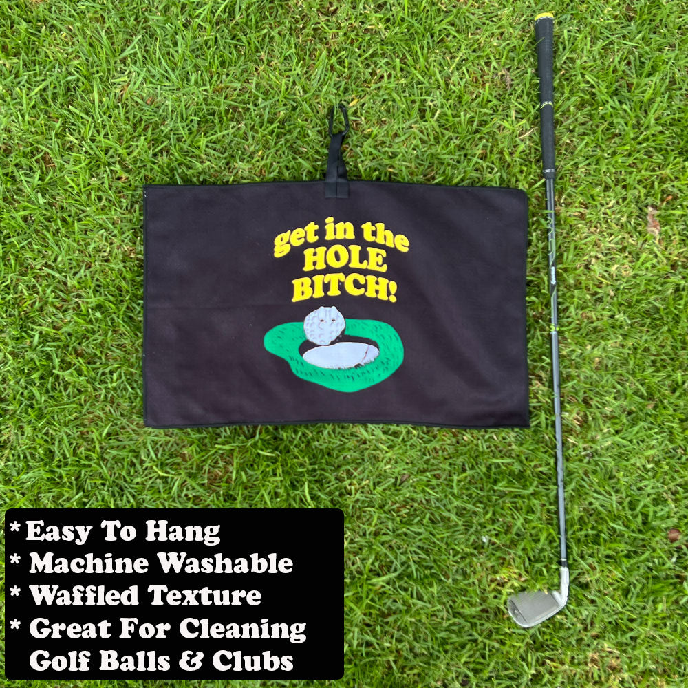 Golf towel with funny putting green saying on grass with golf club