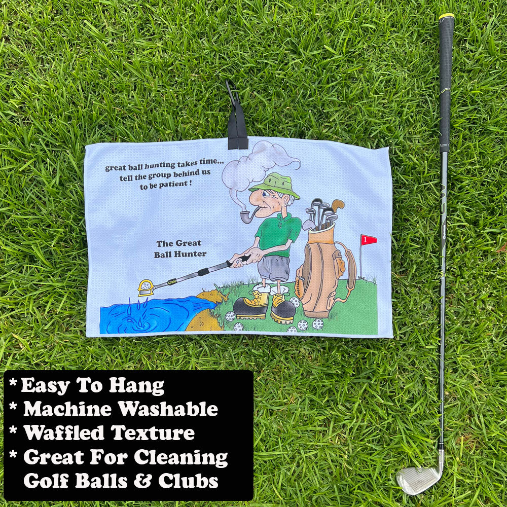 Golf towel with cartoon male golfer on grass with golf club
