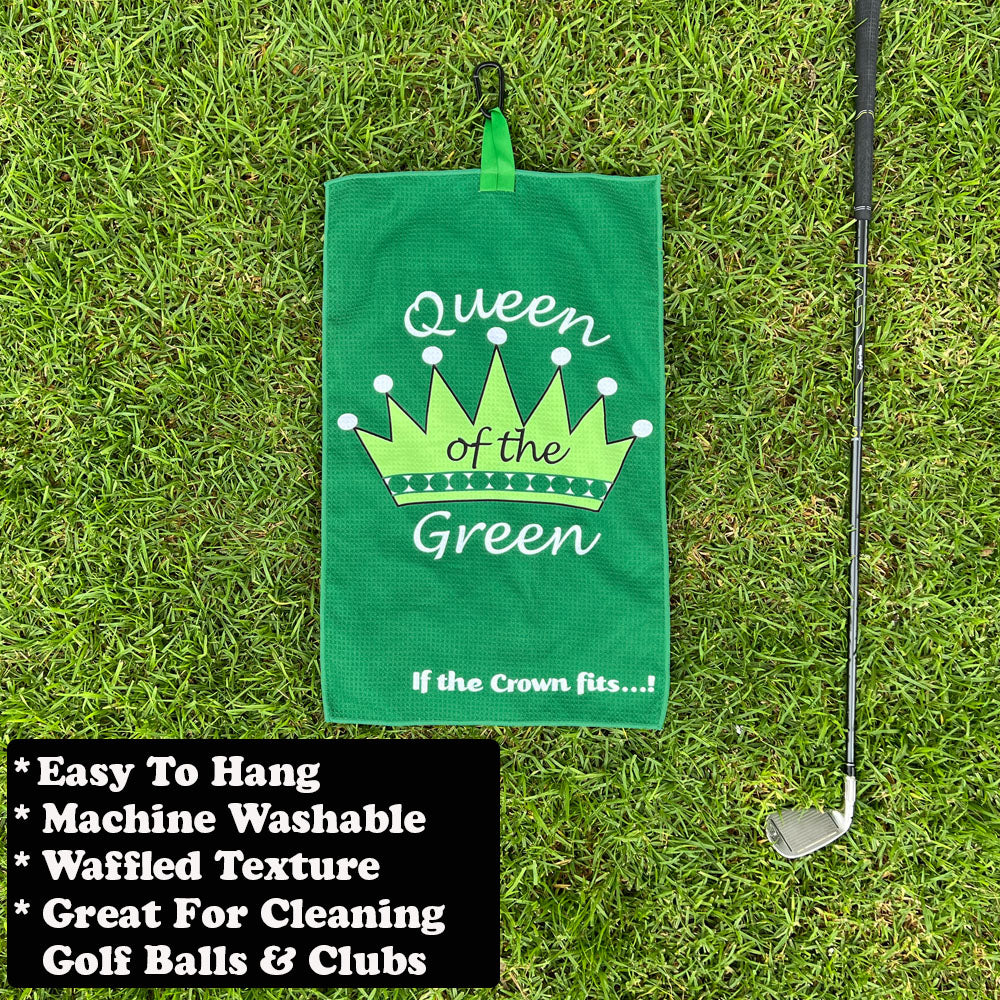Green golf towel with 'Queen of the Green' text on grass with a golf club.