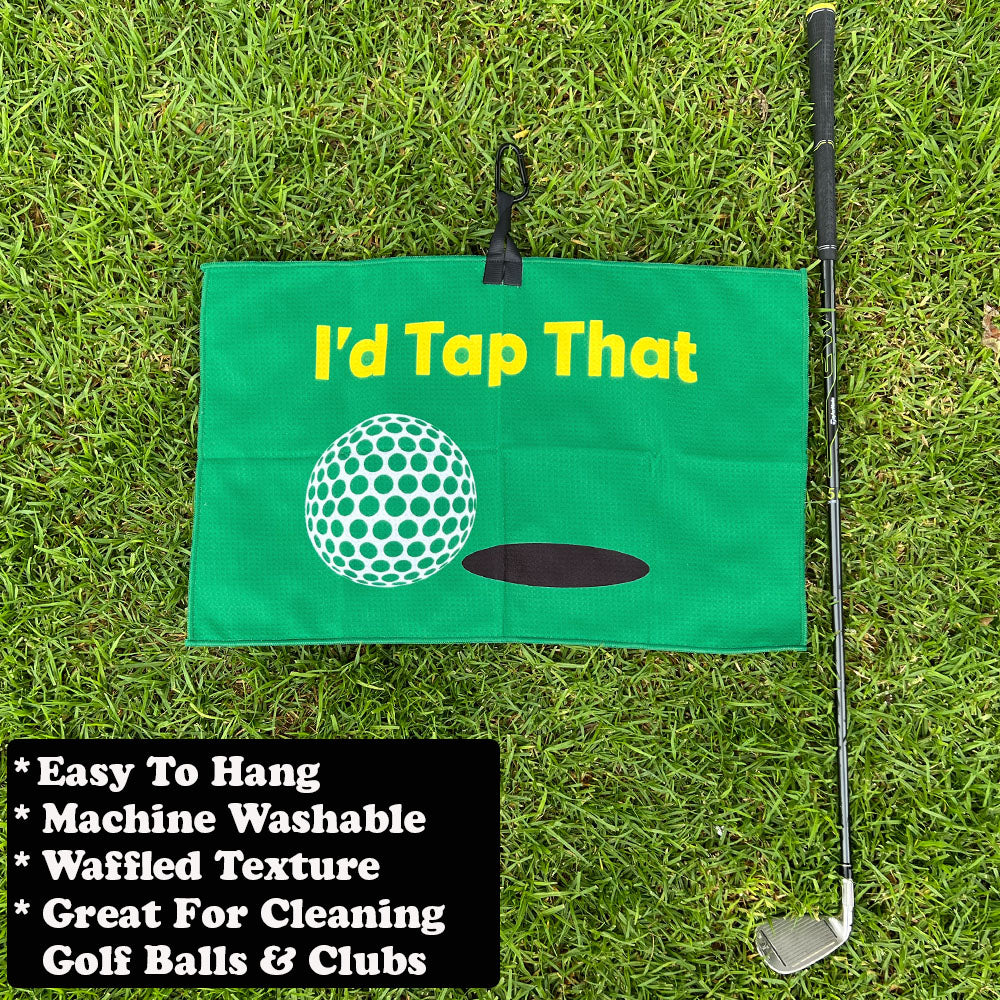 Golf flag with 'I'd Tap That' text and golf club on grass