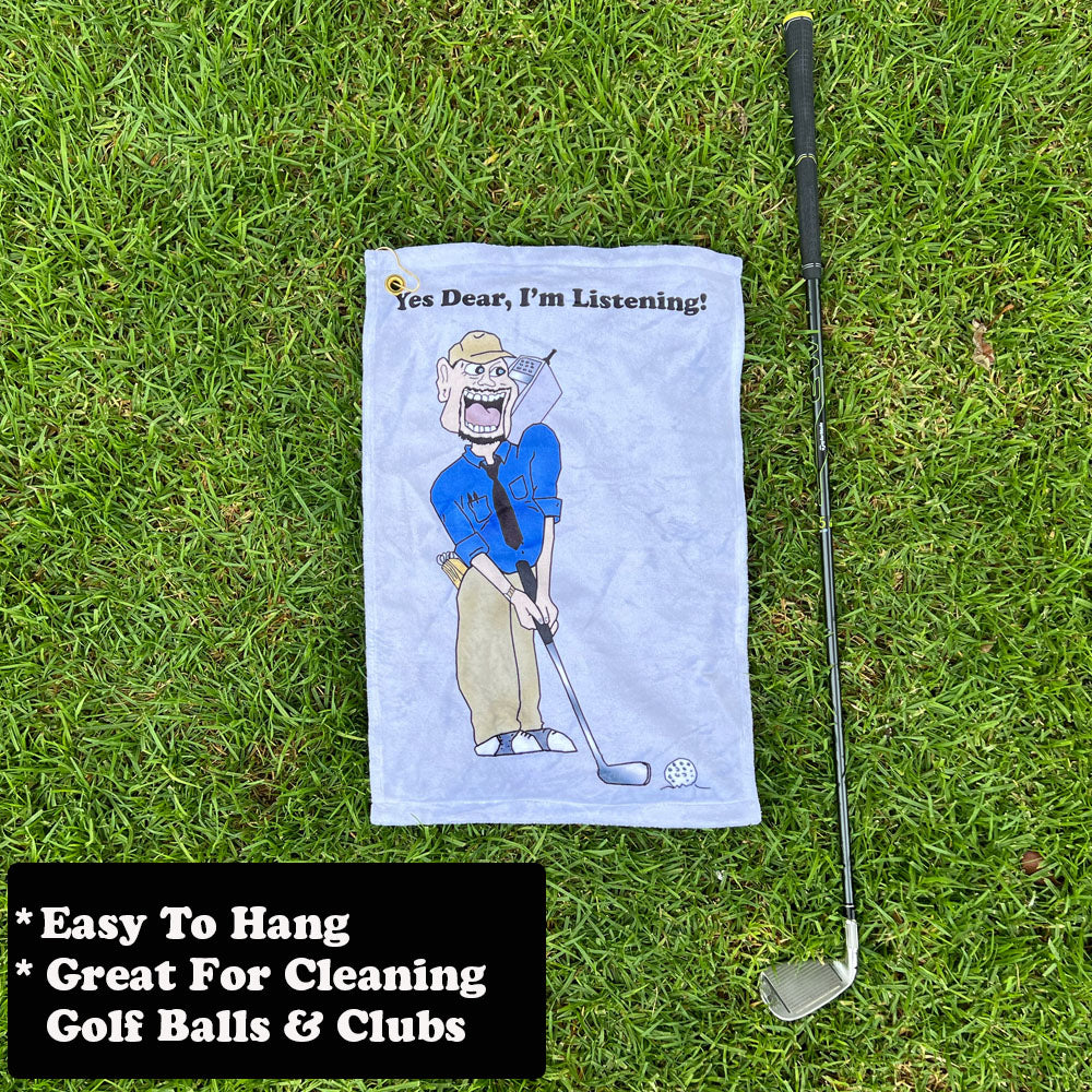 Golf towel with male golfer cartoon character and golf club on grass