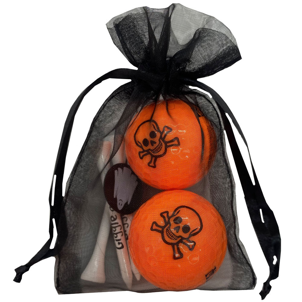 orange golf balls with skull and crossbones design with four wooden golf tees