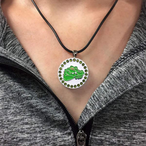 a woman wearing a bling green alligator golf ball marker necklace