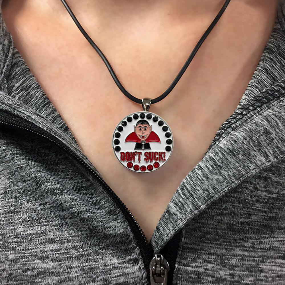 Example of bling Dracula (vampire) golf ball marker necklace on a woman.