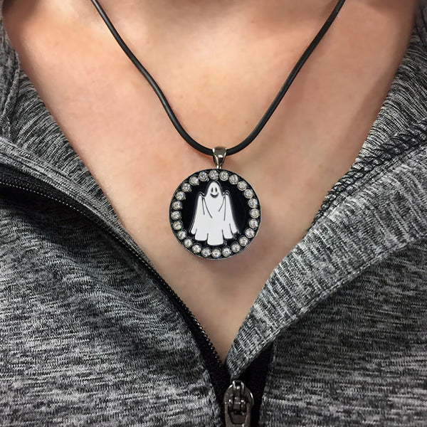 a woman wearing a bling ghost golf ball marker necklace
