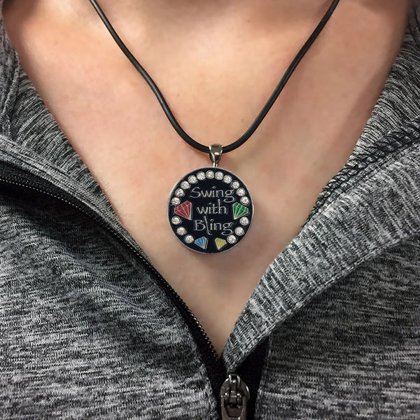 a woman wearing the swing with bling (black background) golf ball marker necklace