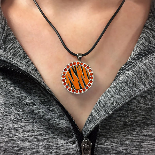 a woman wearing the bling orange and black tiger stripes golf ball marker necklace