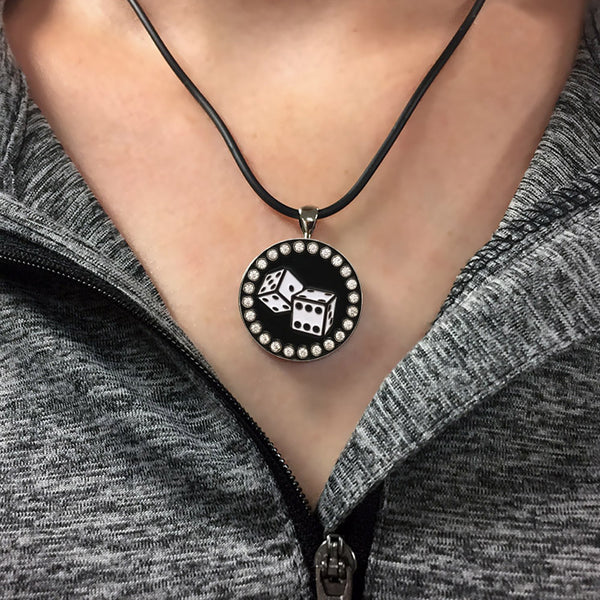 a woman wearing the bling black & white dice golf ball marker necklace