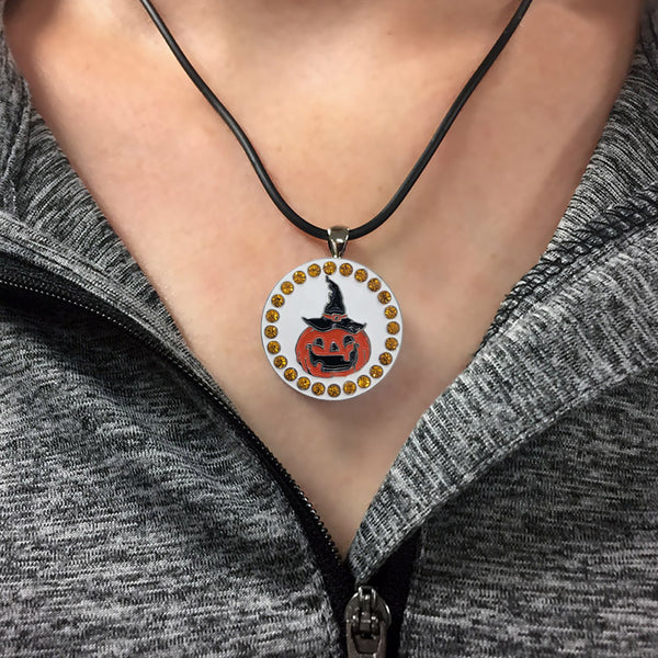 a woman wearing a bling pumpkin golf ball marker necklace