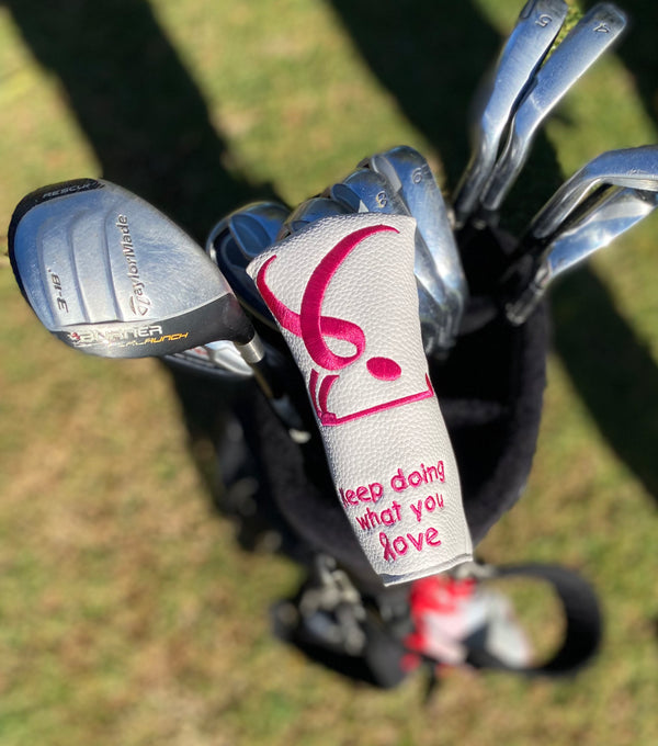 giggle golf pink ribbon (breast cancer awareness) blade on a putter in a golf bag